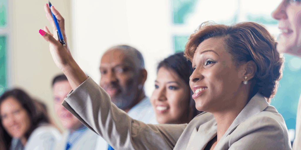 Nonprofit Board member raising hand with a question about financial statements